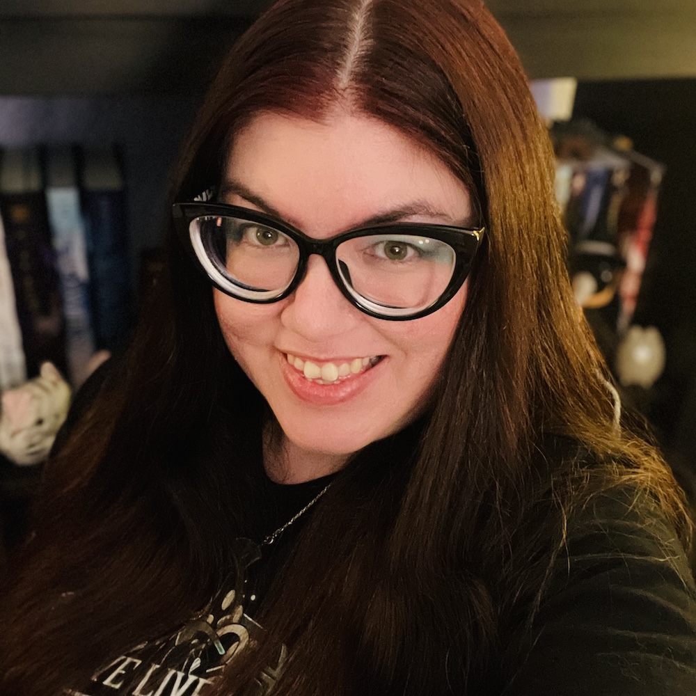 Kat Vancil in front of a bookcase in her story studio
